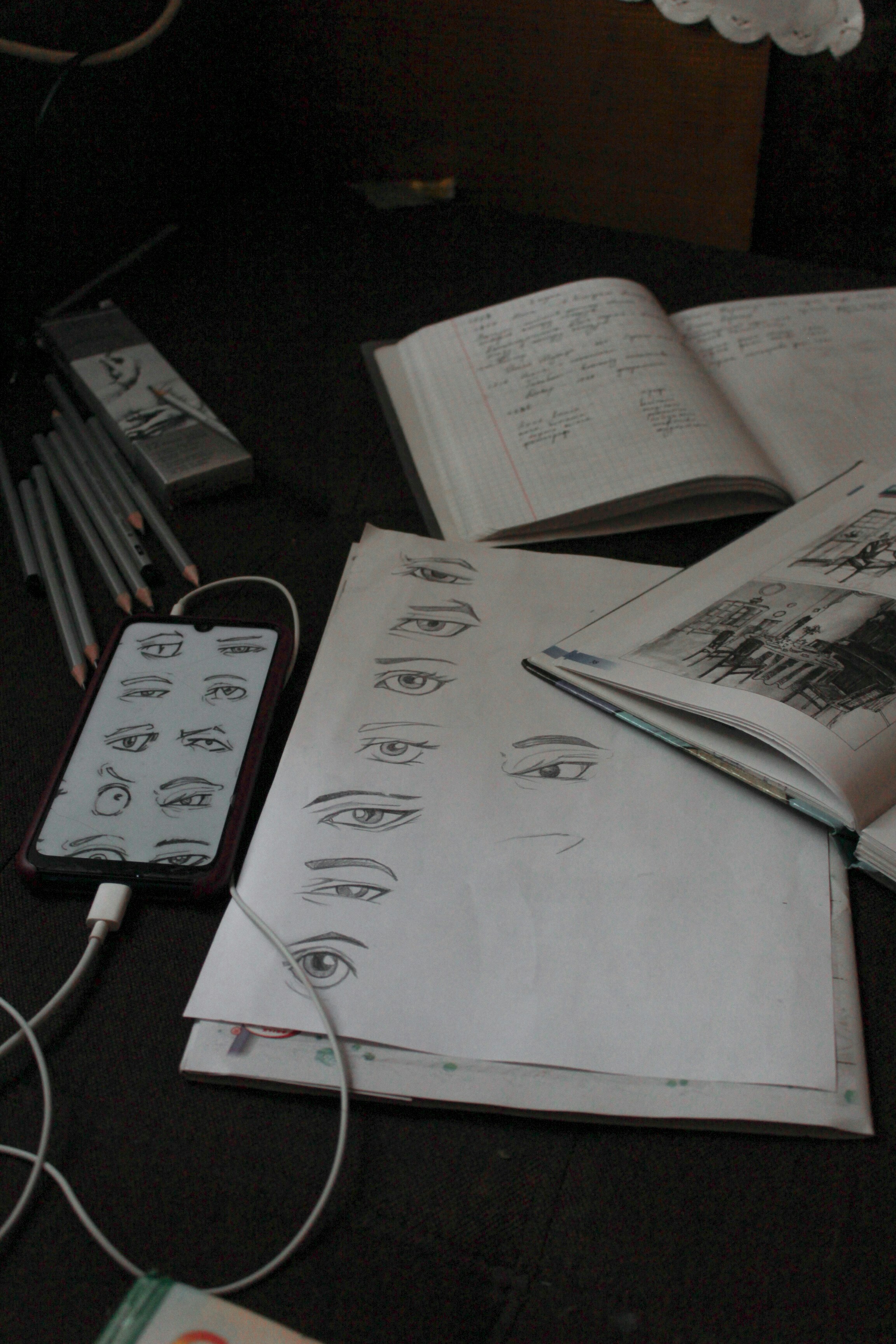 a bunch of papers and a cell phone on a table